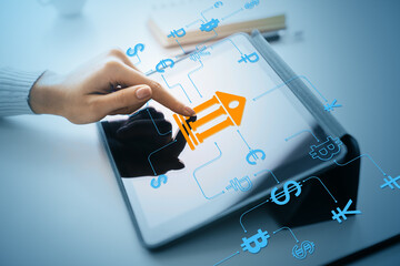 Finger touching digital banking icon on tablet screen with financial technology symbols and...