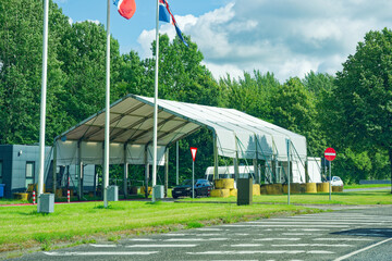The border crossing between Denmark and Germany in Padborg with Flags and cars