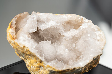 Natural crystal geode showcasing intricate formations of quartz and mineral deposits, highlighting...