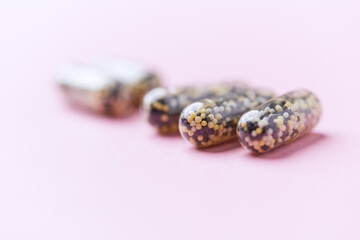 Iron capsules on bright background. Soft focus. Close up. Copy space.	