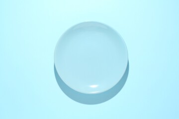 One stylish plate on light blue background, top view