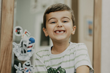 Smiling little boy sitting at barber shop