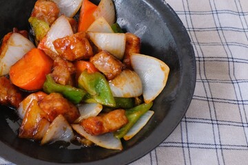 Sweet and sour pork with carrot, green pepper, onion