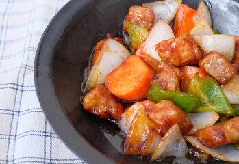 Sweet and sour pork with carrot, green pepper, onion