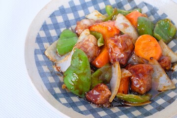 Sweet and sour pork with carrot, green pepper, onion