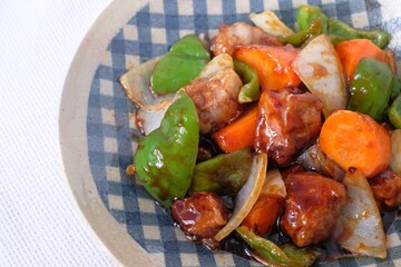 Sweet and sour pork with carrot, green pepper, onion