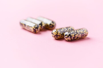 Iron capsules on bright background. Soft focus. Close up. Copy space.	