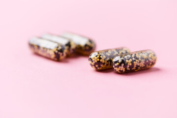 Iron capsules on bright background. Soft focus. Close up. Copy space.	