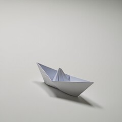 Cool white origami paper boat floats against a plain white background