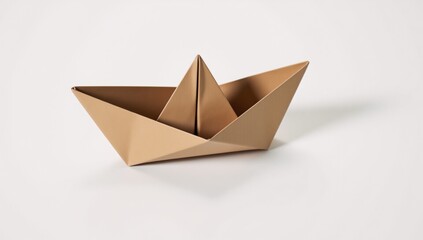An origami boat crafted from brown paper rests on a pristine white background