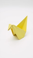 Naklejka premium Ok Origami yellow bird on white background