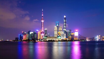 Obraz premium Illuminated cityscape at twilight reflecting on water