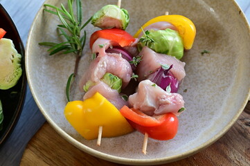 Close-up view of fresh colorful vegetables including bright bell pepper, red onion, and Brussels sprouts.