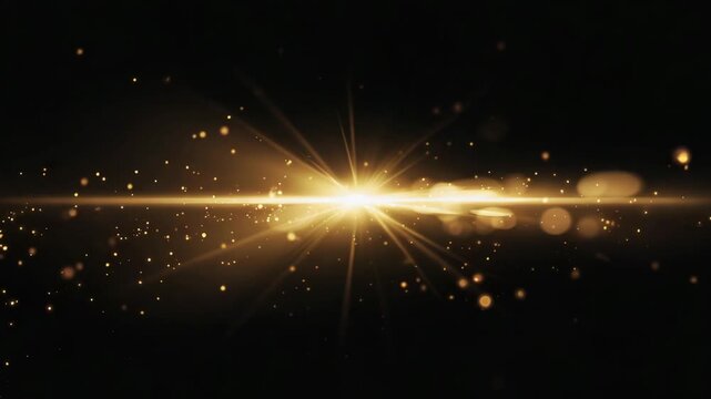 Brilliant golden light flare with sparkling glitter particles and a bokeh effect on a dark abstract background.