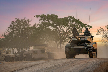 Armored on Patrol, A armored vehicles carrying armed soldiers advances along a dirt path during a...
