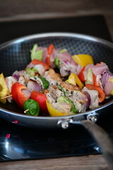 Grilled Chicken Skewer with Vegetables on Frying Pan at Home Kitchen with Induction Stove