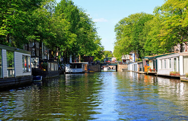 A row of House Boats moored along a canal in Amsterdam, these are permanent residential homes