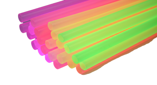 A close up view of a stack of colorful plastic drinking straws on a black background surface on transparent background