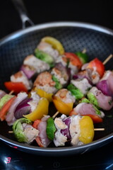 Grilled Chicken Skewer with Vegetables on Frying Pan at Home Kitchen with Induction Stove
