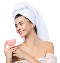 Beautiful cheerful attractive girl with a towel on her head, holds a sponge in the form of a pink...