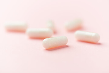 Carnitine capsules. Concept for a healthy dietary supplementation. Bright paper background. Soft focus. Close up.	