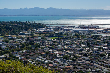Aerial View of Coastal City with Harbor and Mountains