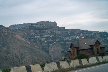 A blurry image of a mountain with a house in the distance