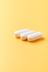 Magnesium tablets on bright paper background. Soft focus. Close up. Copy space	