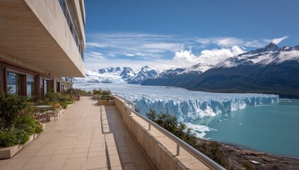 Obraz premium Balcony overlooking a glacier. Modern building with a patio, overlooking Perito Moreno Glacier, turquoise water, and snow-capped peaks. Sunny day