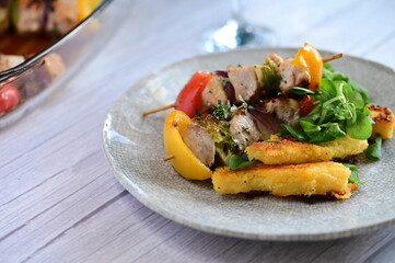 Grilled Chicken Skewer with Vegetables, Polenta and Fresh Greens