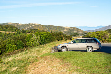 Parked Station Wagon Overlooking Scenic Hills