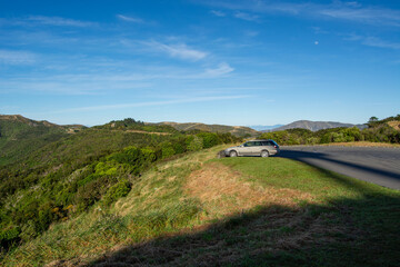 Scenic Landscape with Parked Car on a Hill