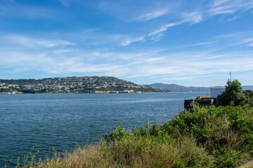 Scenic Waterfront View with Hills and Clear Sky