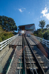 Obraz premium Steep Railway Track Leading to Modern Station