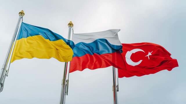 Dynamic flags of Ukraine, Russia and Turkey waving against a bright sky in a powerful display