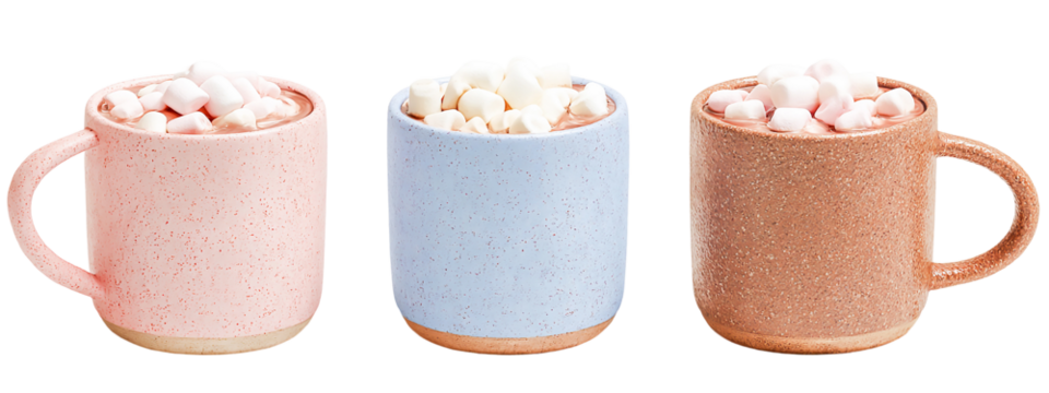 Three mugs of hot chocolate with marshmallows isolated on transparent background