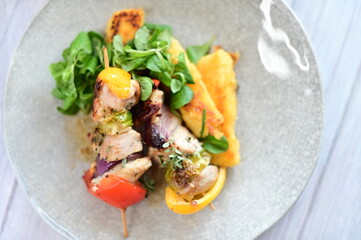 Grilled Chicken Skewer with Vegetables, Polenta and Fresh Greens