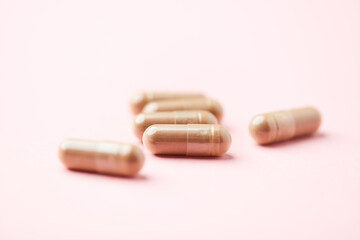 Ginseng capsules on bright background. Soft focus. Close up. Copy space	