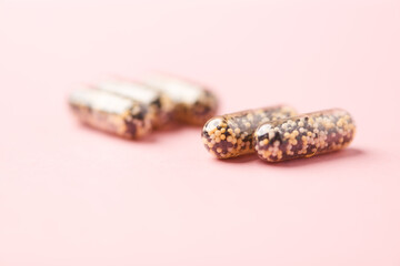 Iron capsules on bright background. Soft focus. Close up. Copy space.