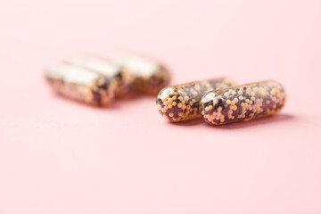 Iron capsules on bright background. Soft focus. Close up. Copy space.