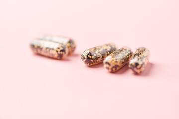 Iron capsules on bright background. Soft focus. Close up. Copy space.