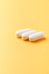 Magnesium tablets on bright paper background. Soft focus. Close up. Copy space	