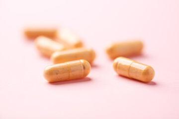 Vitamin B complex capsules on bright paper background. Soft focus. Close up. Copy space.	