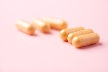 Vitamin B complex capsules on bright paper background. Soft focus. Close up. Copy space.	