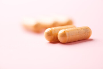 Vitamin B complex capsules on bright paper background. Soft focus. Close up. Copy space.	