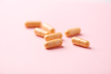 Vitamin B complex capsules on bright paper background. Soft focus. Close up. Copy space.