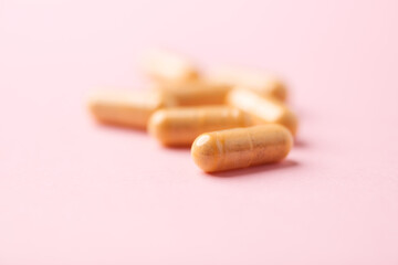 Vitamin B complex capsules on bright paper background. Soft focus. Close up. Copy space.