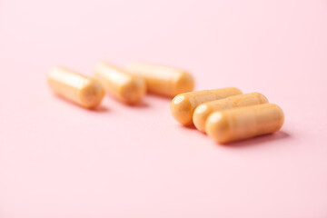 Vitamin B complex capsules on bright paper background. Soft focus. Close up. Copy space.