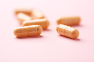 Vitamin B complex capsules on bright paper background. Soft focus. Close up. Copy space.