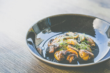 Sautéed Mushrooms with butter and herb served in a black dish
